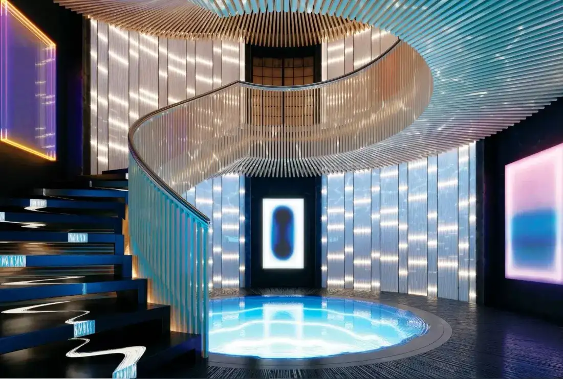 Luxurious interior of Bill Gates' hydrogen-powered yacht showing the stunning spiral staircase, ambient lighting and futuristic design elements characteristic of the vessel's premium craftsmanship