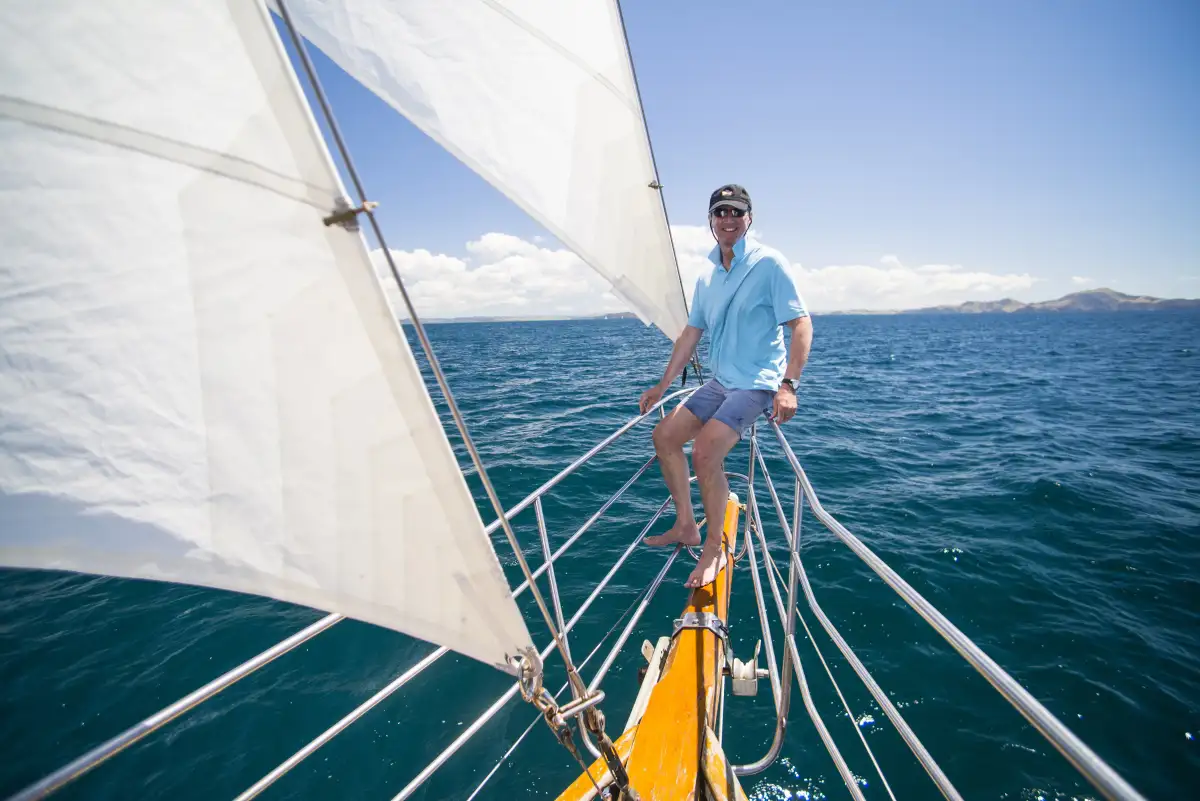 Solo sailor navigating Turkish waters at sunset, embodying the pure freedom of single-handed sailing