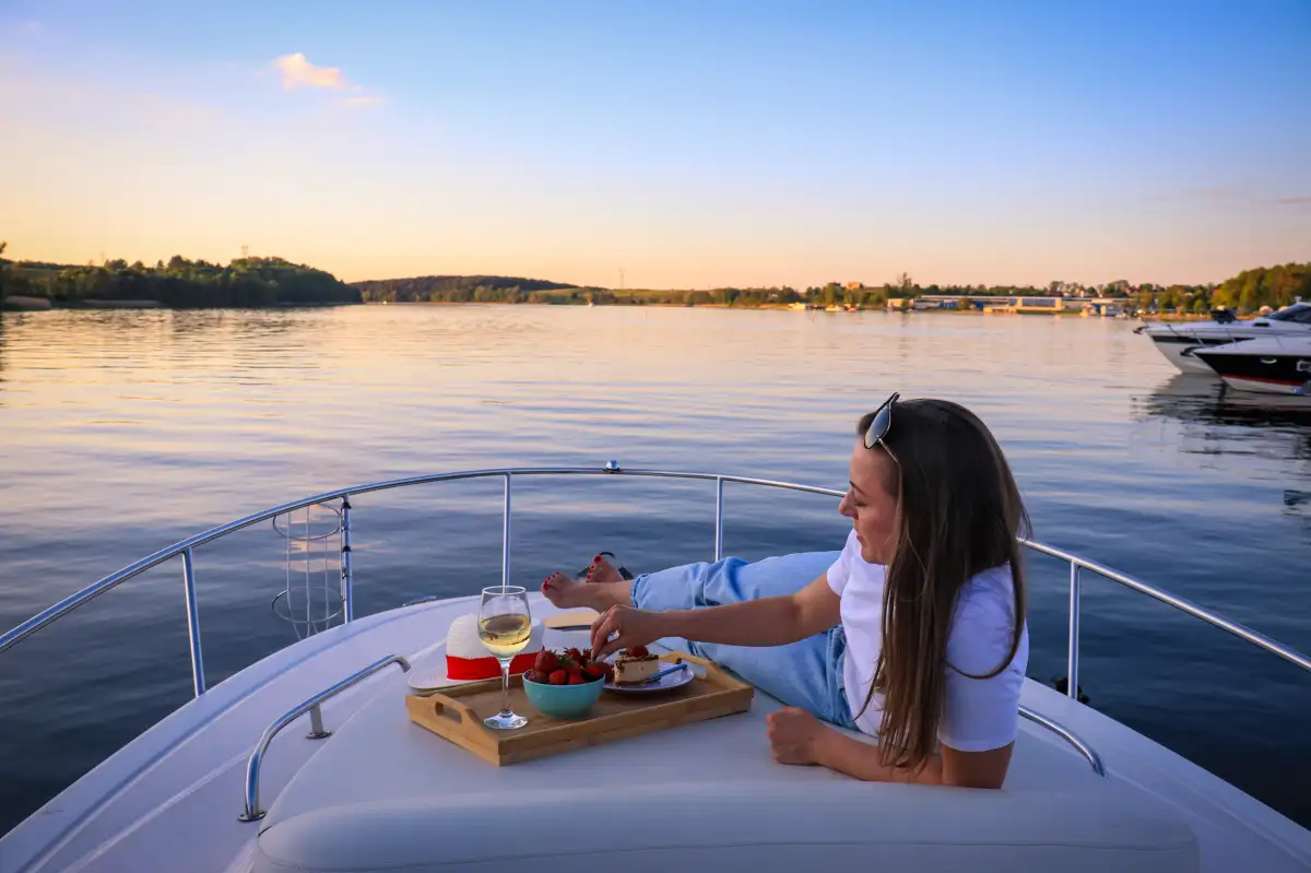 Evening relaxation on a yacht during island hopping - enjoying local delicacies and wine on deck while watching the sunset