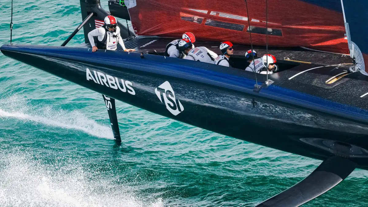 AC75 racing yacht demonstrating advanced foiling technology that lifts the hull above water for maximum speed