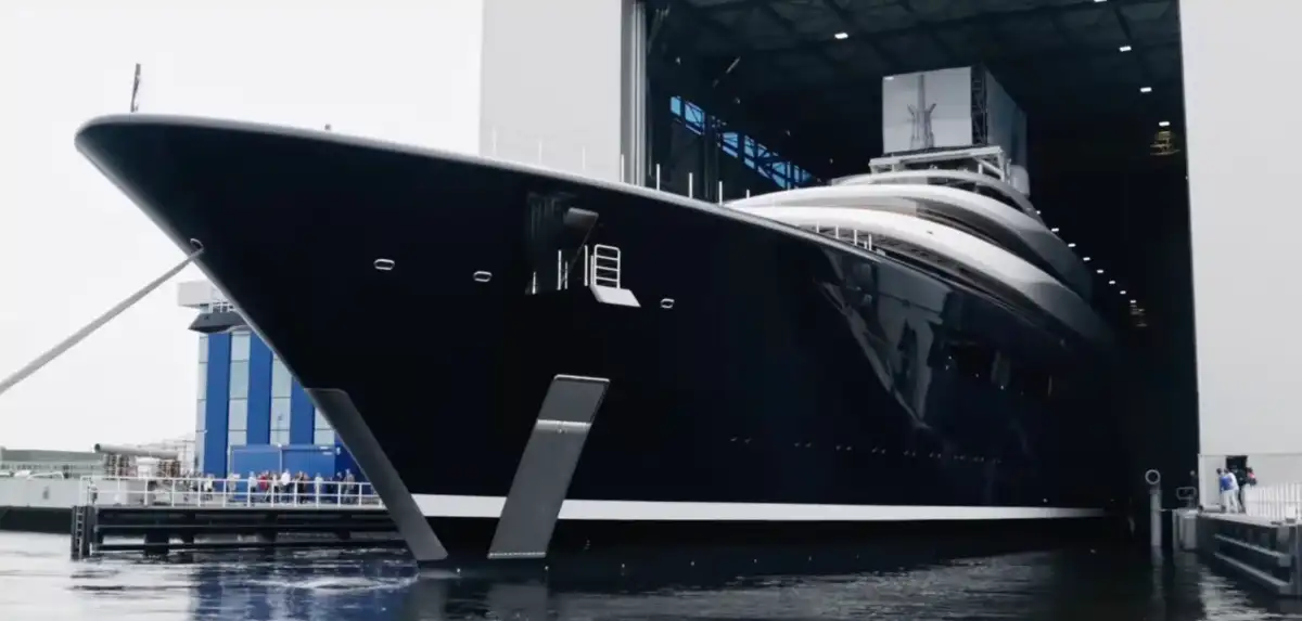 Aerial view of the sleek 388-foot 'Breakthrough' superyacht commissioned by Bill Gates featuring its distinctive curved design and innovative architecture
