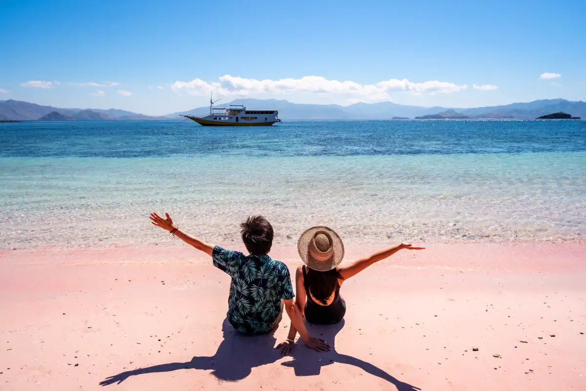 Adventure cruise passengers observing Galapagos wildlife including the iconic blue-footed boobies from a zodiac boat