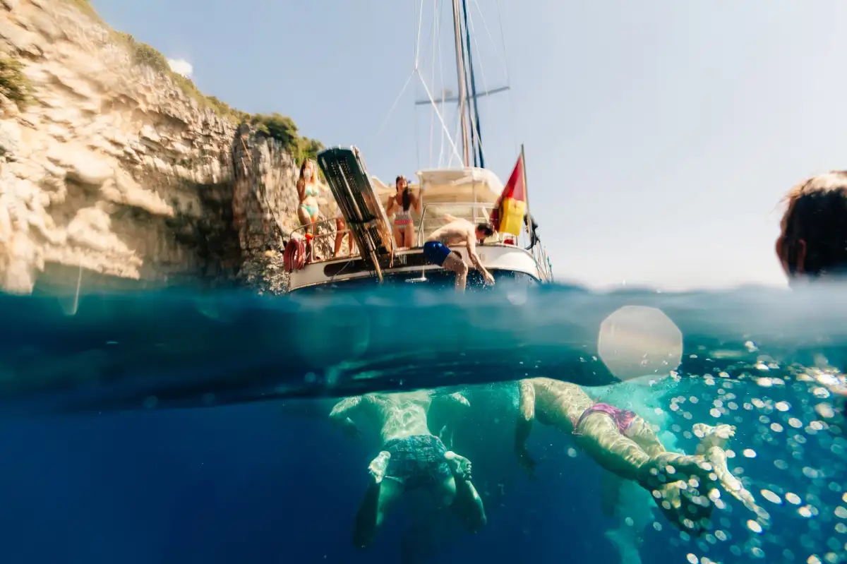 Travelers enjoying underwater swimming and snorkeling in the crystal-clear turquoise waters of Turkey's Mediterranean coast, a highlight activity of gulet sailing holidays